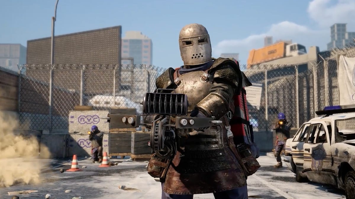 a person in metal armor points a custom weapon at the screen