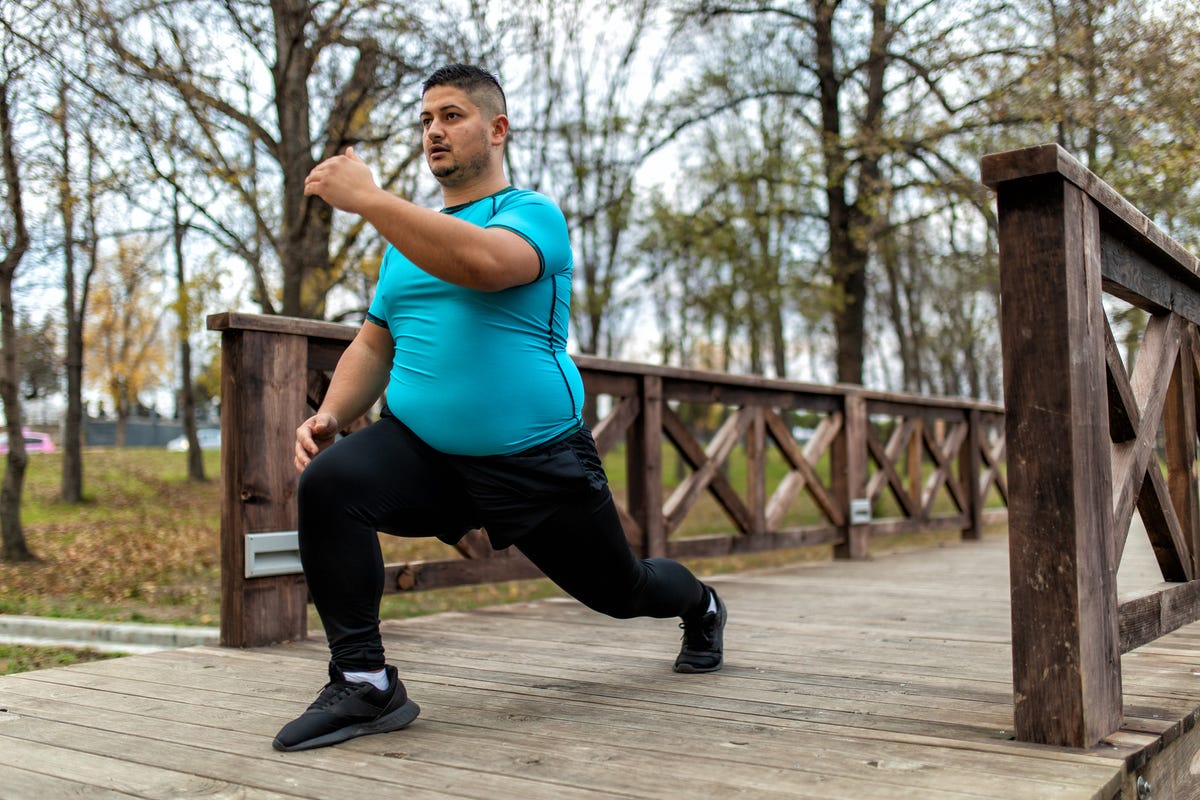Man doing a lunge outdoors.