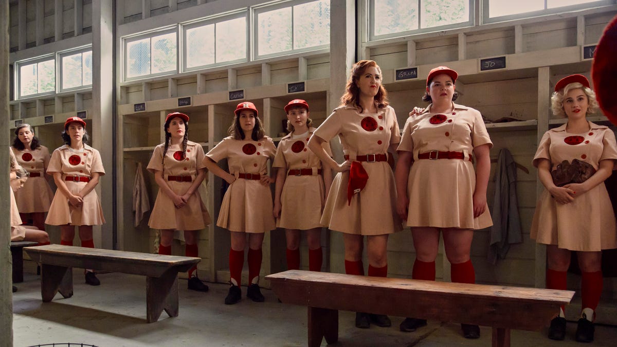 The Rockford Peaches stand in a line in their locker room.