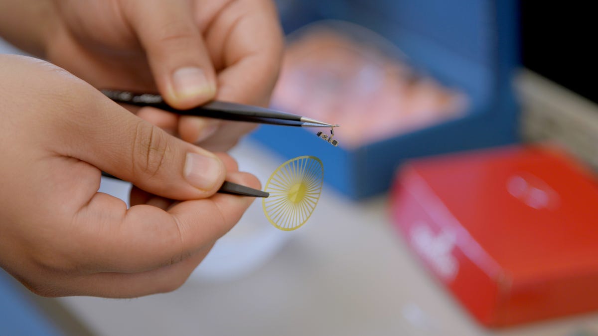 A gold colored plastic disc and tiny electronics make up the sensor