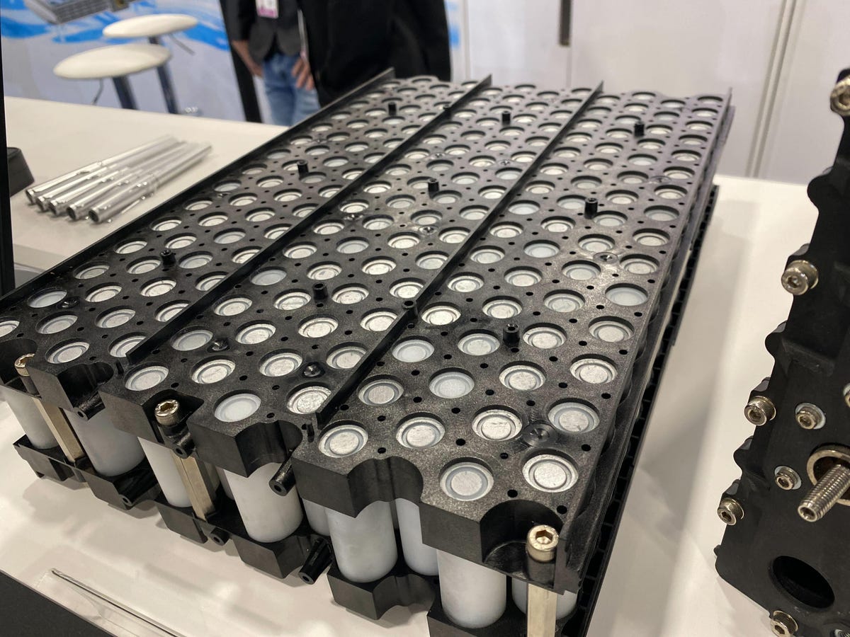 An array of batteries on a table in a booth at CES 2024.