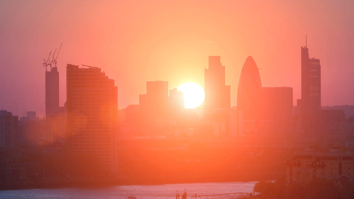 London city skyline against a blazing red sun