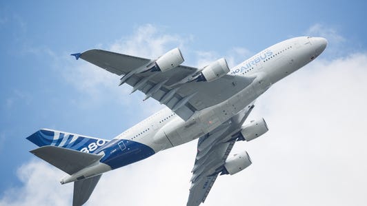 An Airbus A380-800 ascends steeply at the Farnborough International Airshow in the UK.