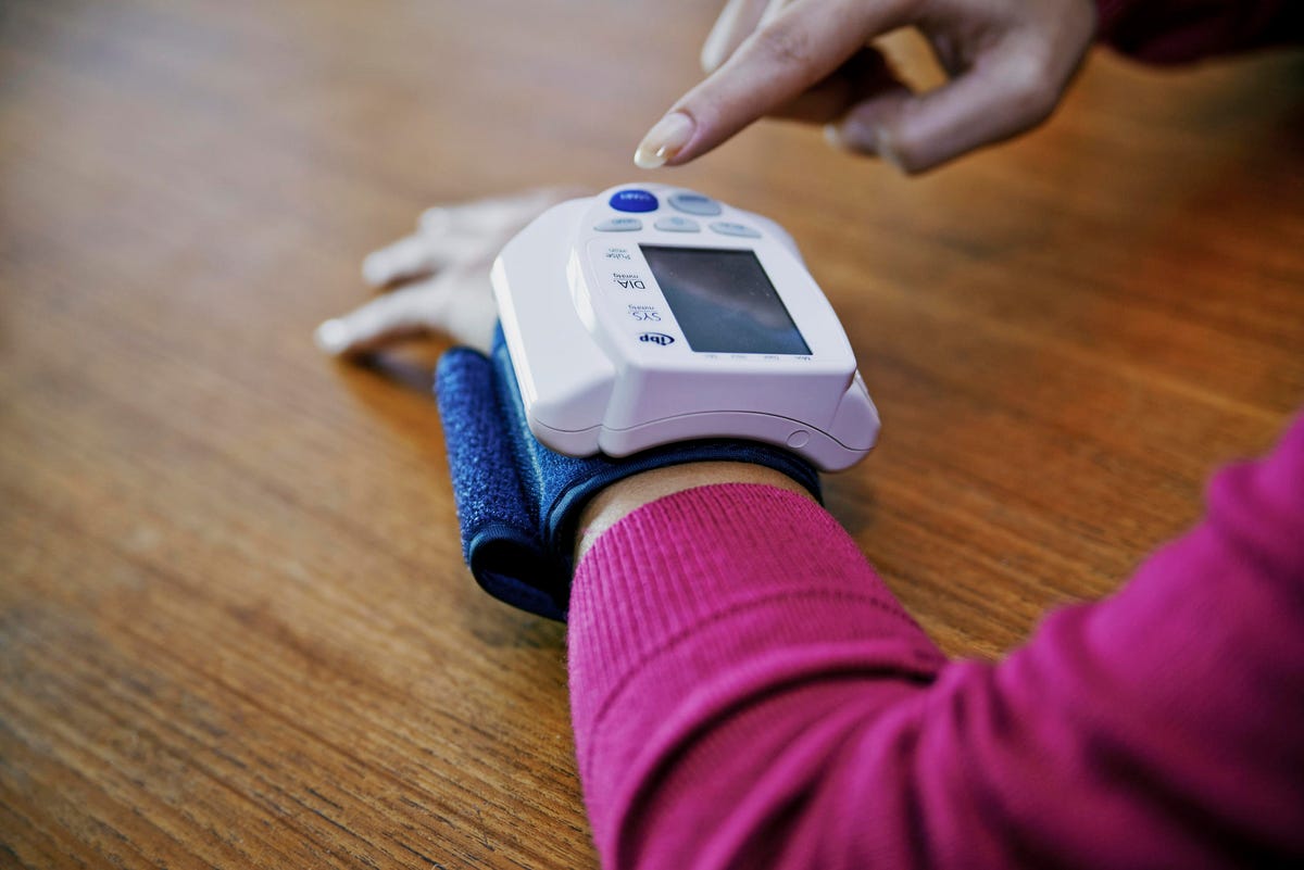 Woman measuring her blood pressure, France