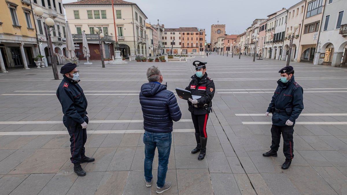 Carabinieri check a man's credentials during the coronavirus lockdown