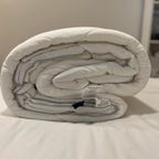 SlumberCloud Comforter on white bed.