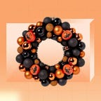 The Hyde & EEK! Boutique Festival of Frights wreath is displayed against an orange background.