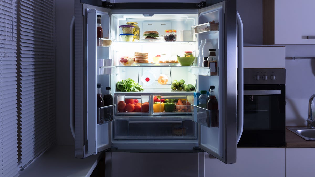 A well-stocked refrigerator with doors open