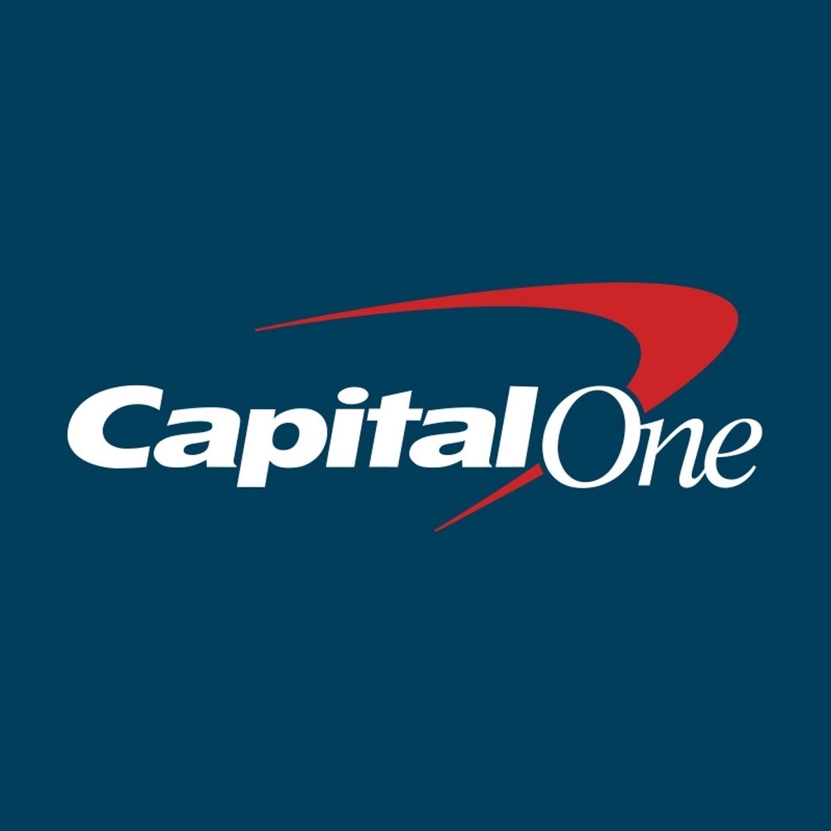 "Capital One" in white italic font laid over the signature red boomerang on a blue background.