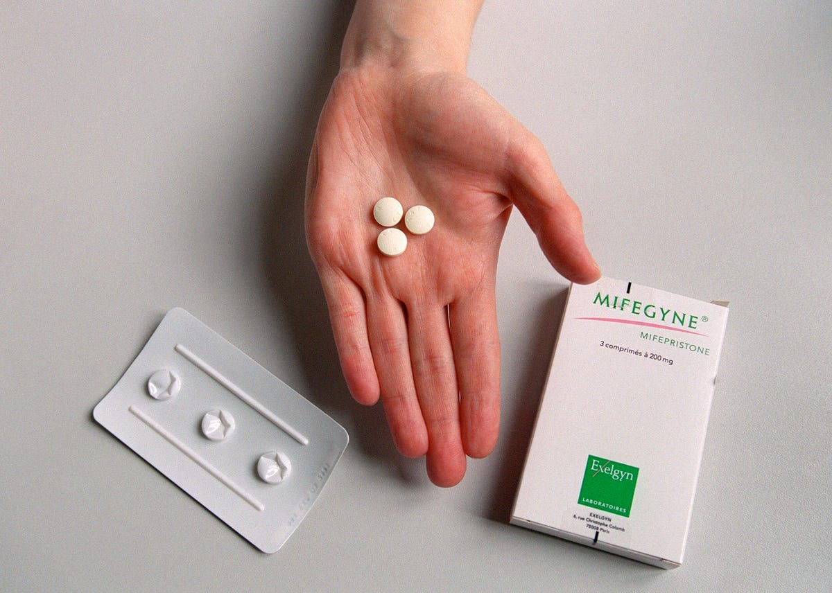 Hand holding the abortion pill