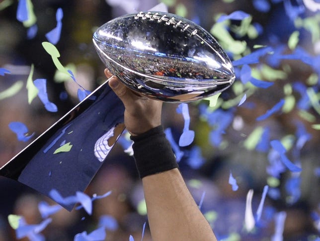 Seahawks quarterback Russell Wilson holds the Vince Lombardi Trophy following victory over the Broncos in last year's Super Bowl.