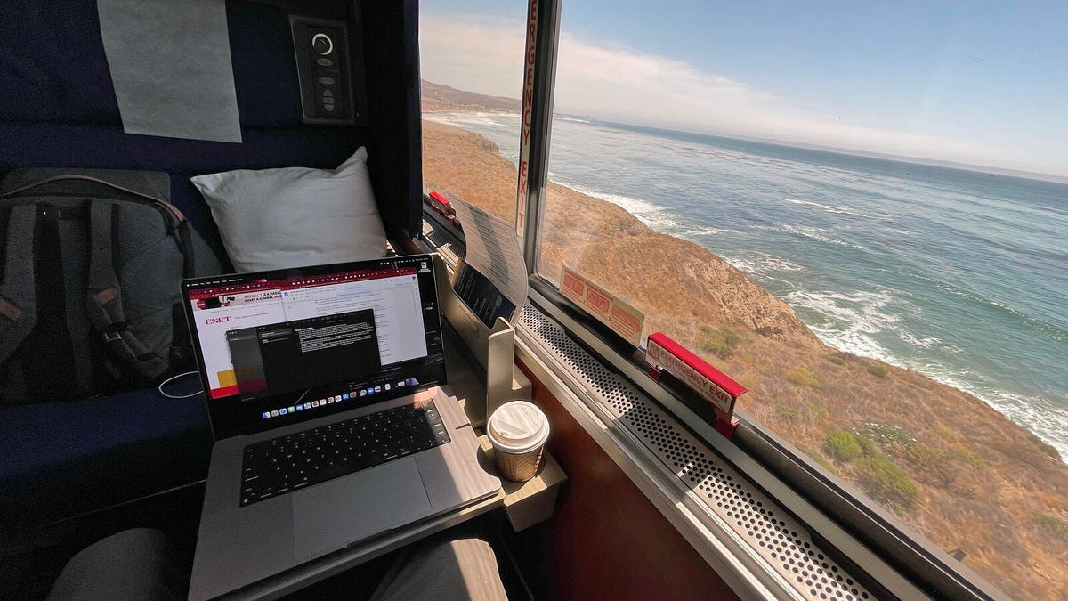 The reporter's laptop (tragically cut off from the internet) on a table in front of a window with a view to the more rugged, beachless California coast north of San Luis Obispo.