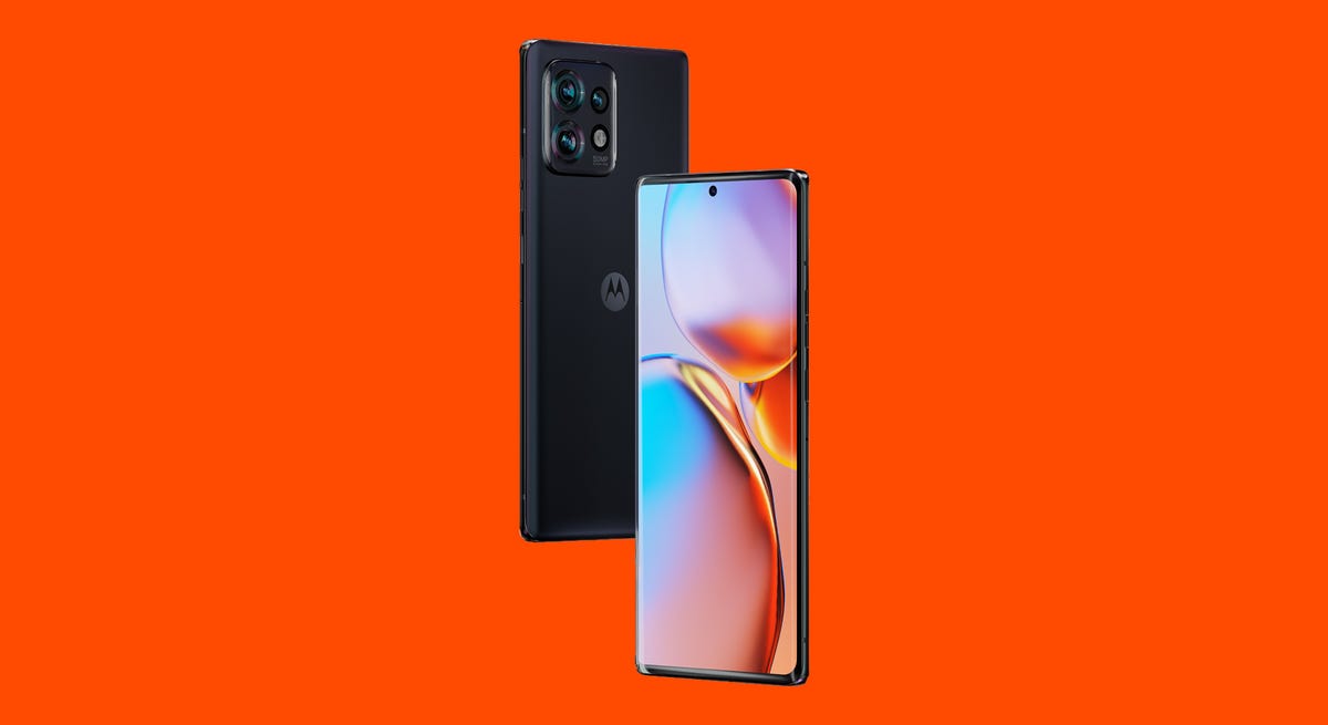 A black phone with three rear cameras on an orange background