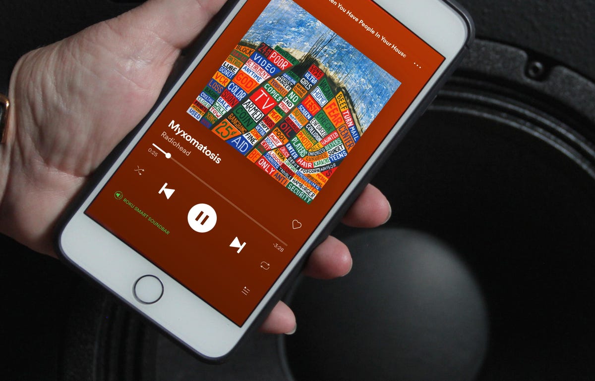 Spotify app on iPhone in front of speaker