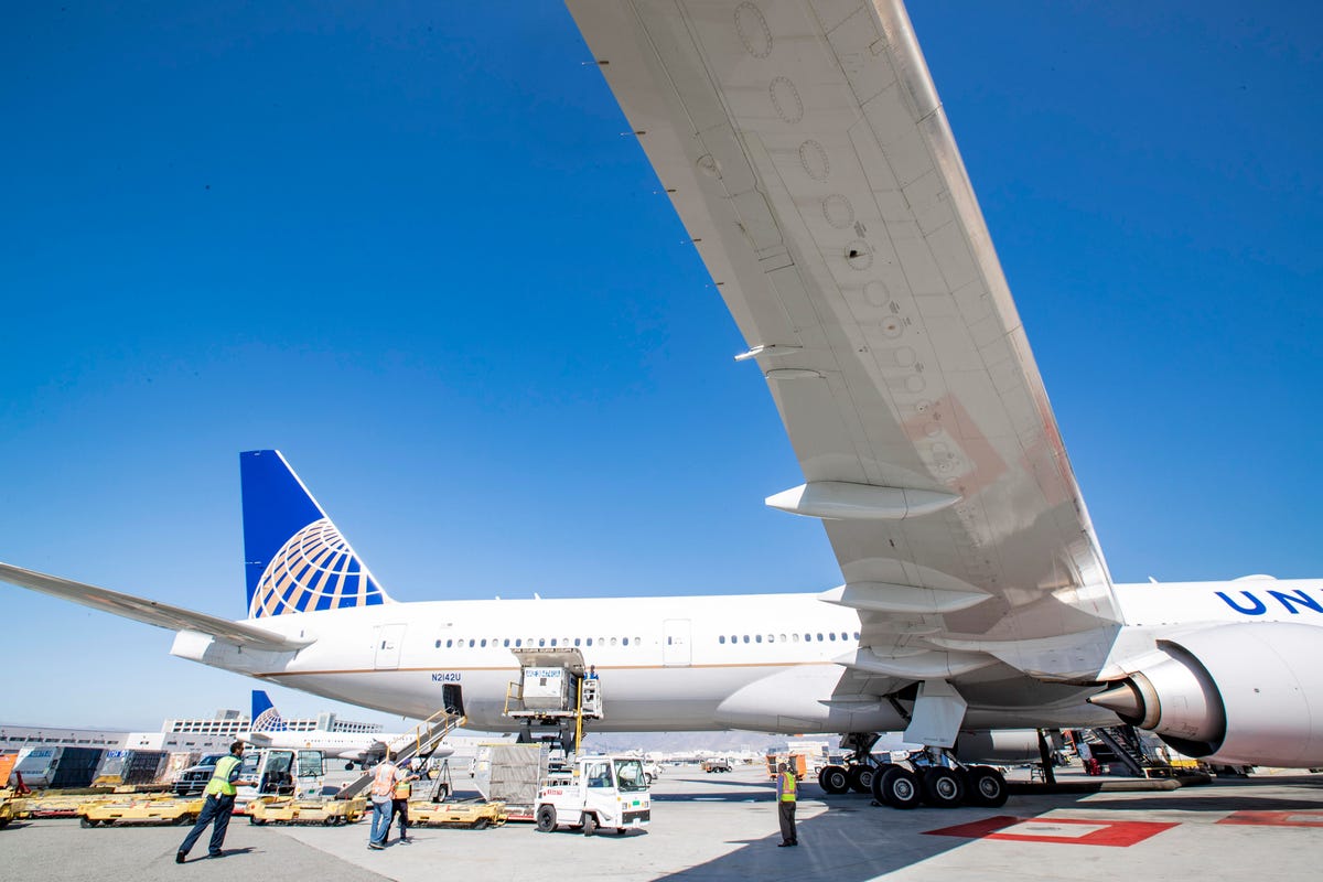 Activity around a United Airlines aircraft during servicing.
