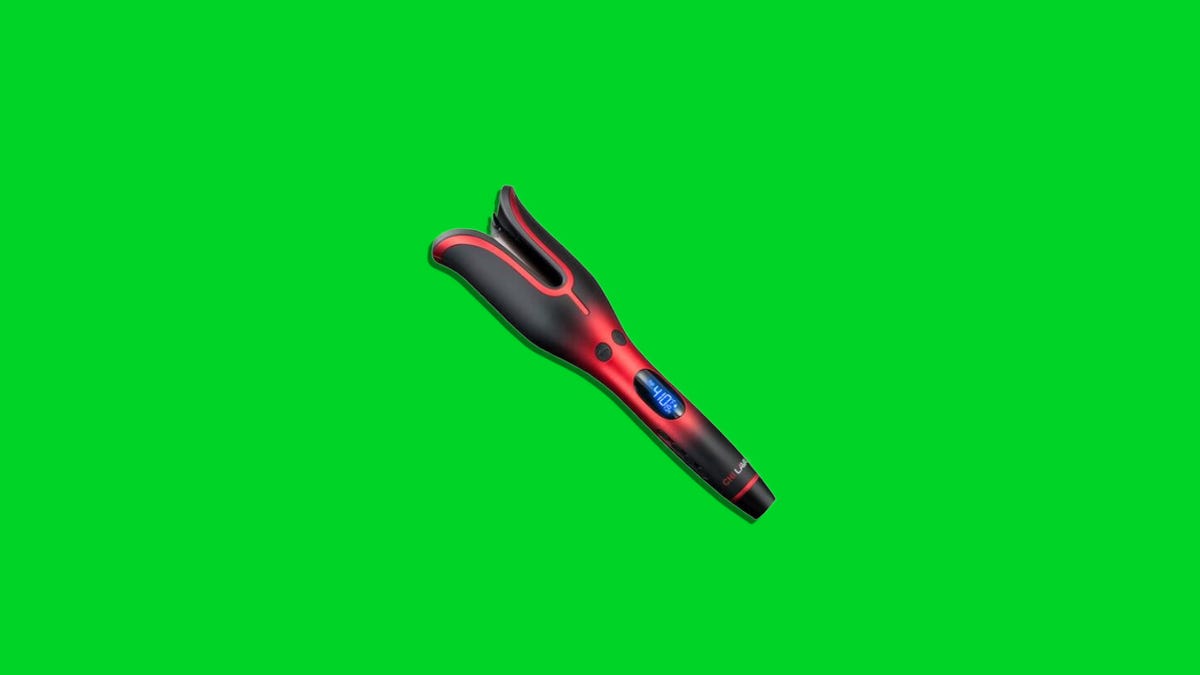 A red and black Chi hair curler on a green background