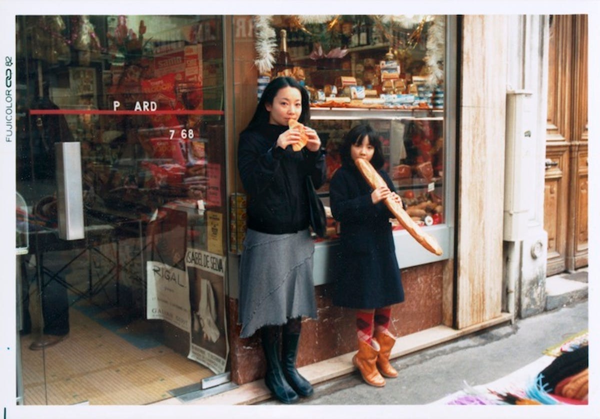 Photographer Chino Otsuka as her 2005 and 1982 self sharing a snack in Paris, France.