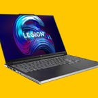 An open Lenovo Legion 7 gaming laptop against a yellow background.