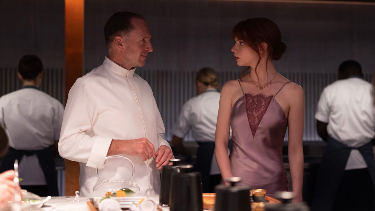 Ralph Fiennes and Anya Taylor-Joy talk in the kitchen in The Menu.
