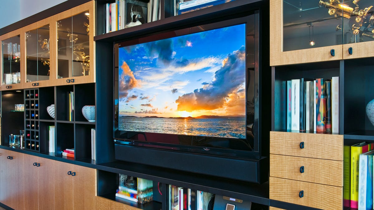 A TV sits in a built-in bookcase.