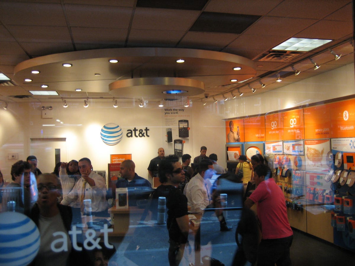 AT&T is allowing only 10 people in the store at a time. Through the glass door, we can take a peek at customers getting their iPhone purchases processed.