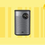 The Xgimi Halo Plus portable projector is displayed against a yellow background.