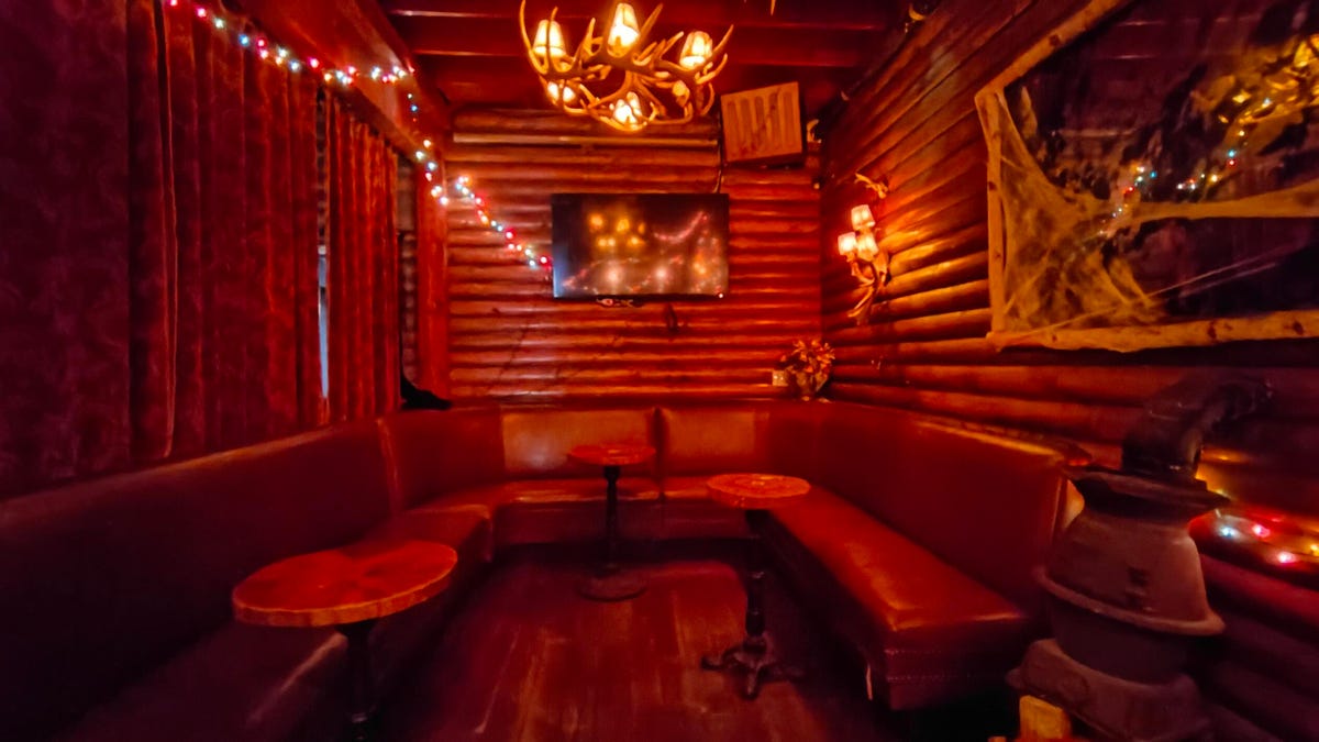 A dim bar interior filled with warm but dim reddish light, which the Razr 2023 makes out blurry.