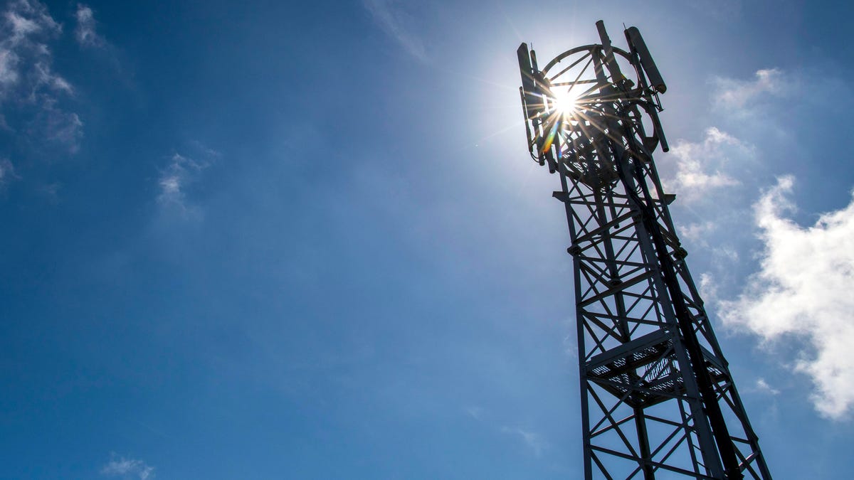 A cellular tower against a sunny, blue sky