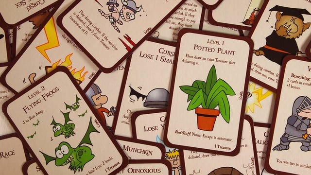 Munchkin cards scattered across the image