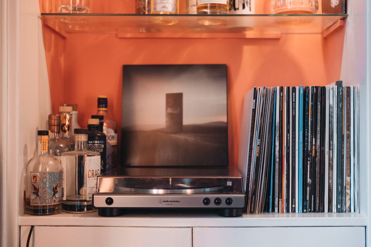A vinyl record player and a record collection.