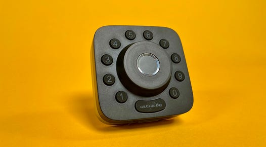 The Ultraloq U-Bolt Pro smart lock with Wi-Fi against a yellow backdrop.