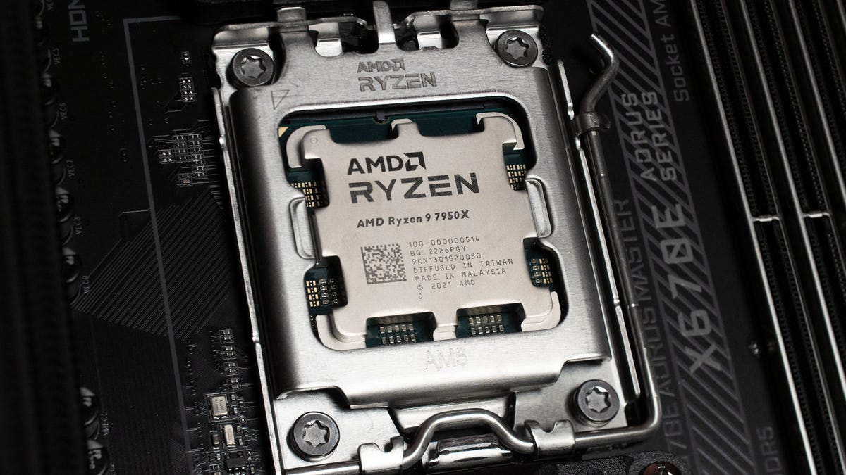 A metallic AMD Ryzen 9 7950X processor plugged into a circuit board