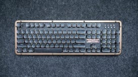 The Azio Retro Classic Prestige full-size mechanical keyboard on a dark gray felt background..