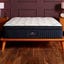 The DreamCloud Premier mattress on a wooden bedframe