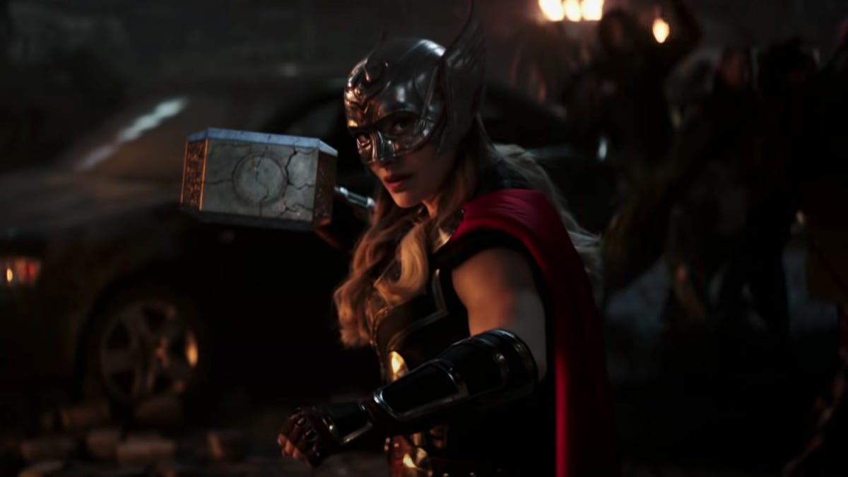 Natalie Portman holding Thor's hammer.