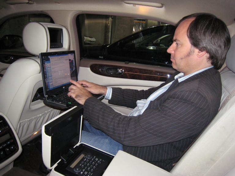 Editor Wayne Cunningham sits in the back of a Jaguar Super V8.