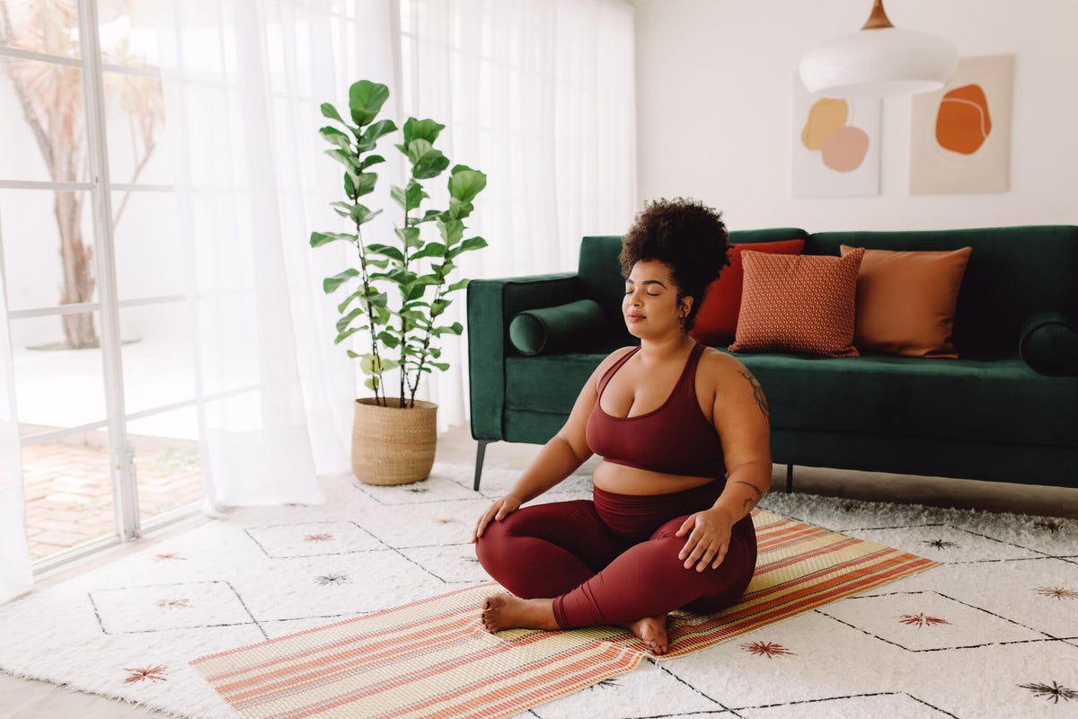 woman practicing meditation at home