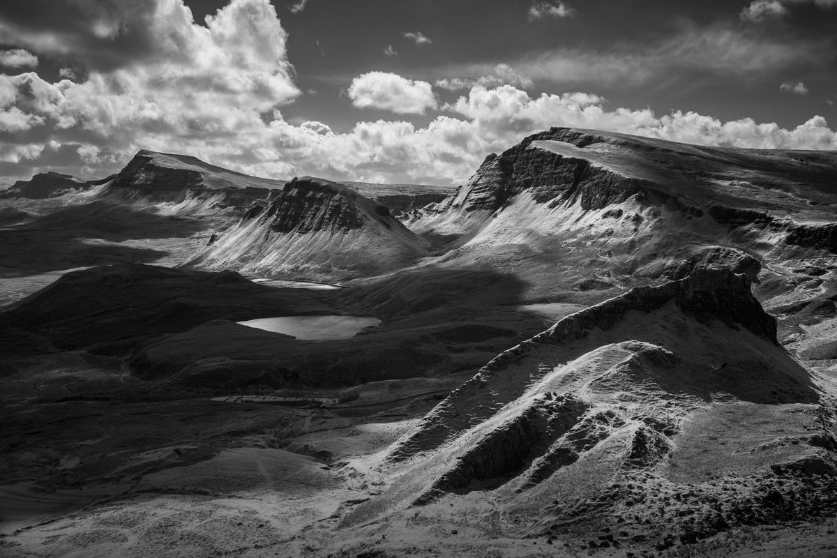 A photo of mountains and clouds in black and white