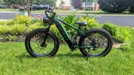 A green ebike with large wheels and Heybike written on the side on a lawn
