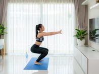 <p>Couple exercises in living room.</p>