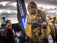 <p>Adam Savage cosplays as Chewbacca the Wookiee, complete with an animatronic C-3PO on his back.</p>