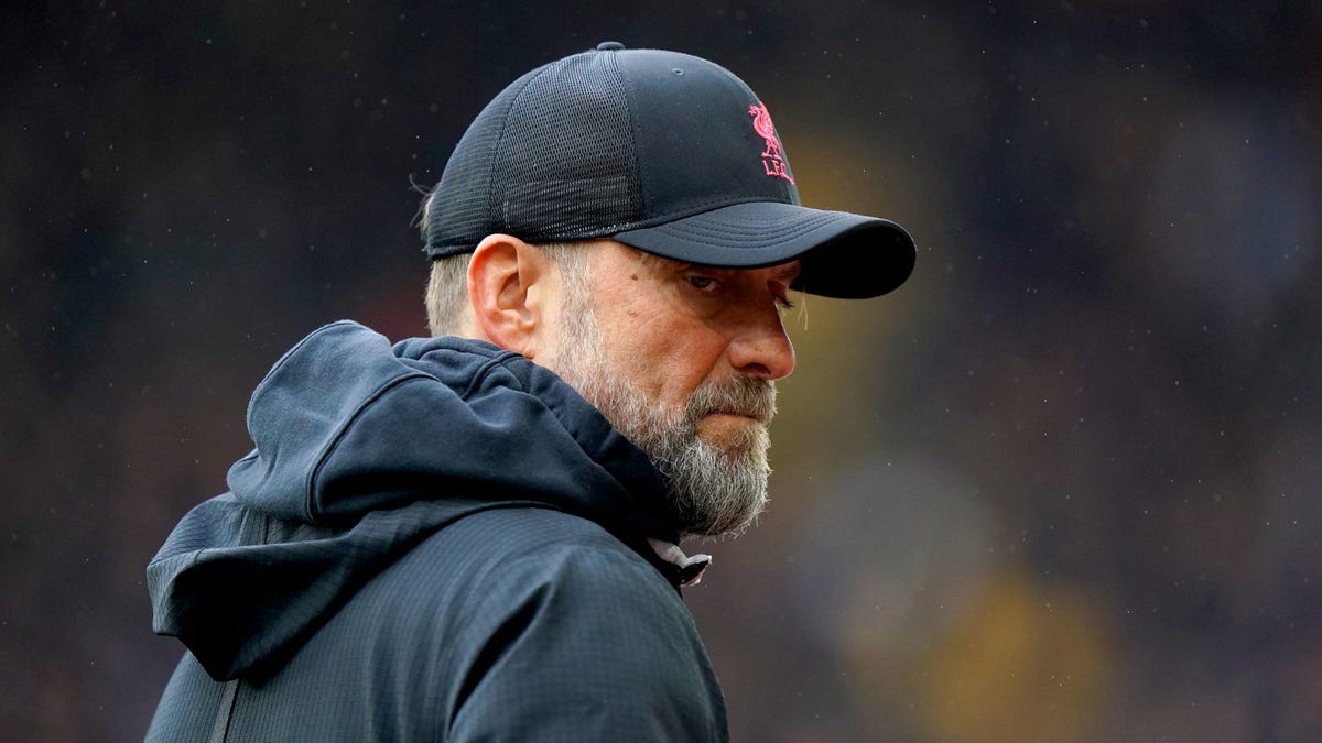 Liverpool manager Jurgen Klopp wears a baseball cap and looks to the right.