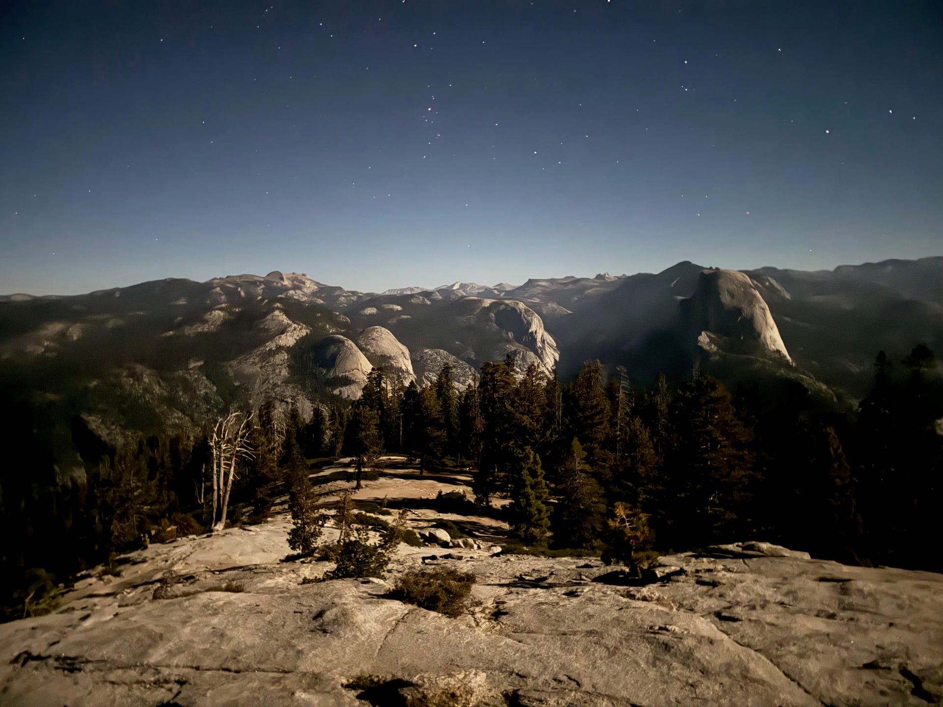 Half Dome seen from atop Sentinel Dome at night, shot on iPhone 15 Pro Max Main camera lens, more than an hour and a half after sunset.