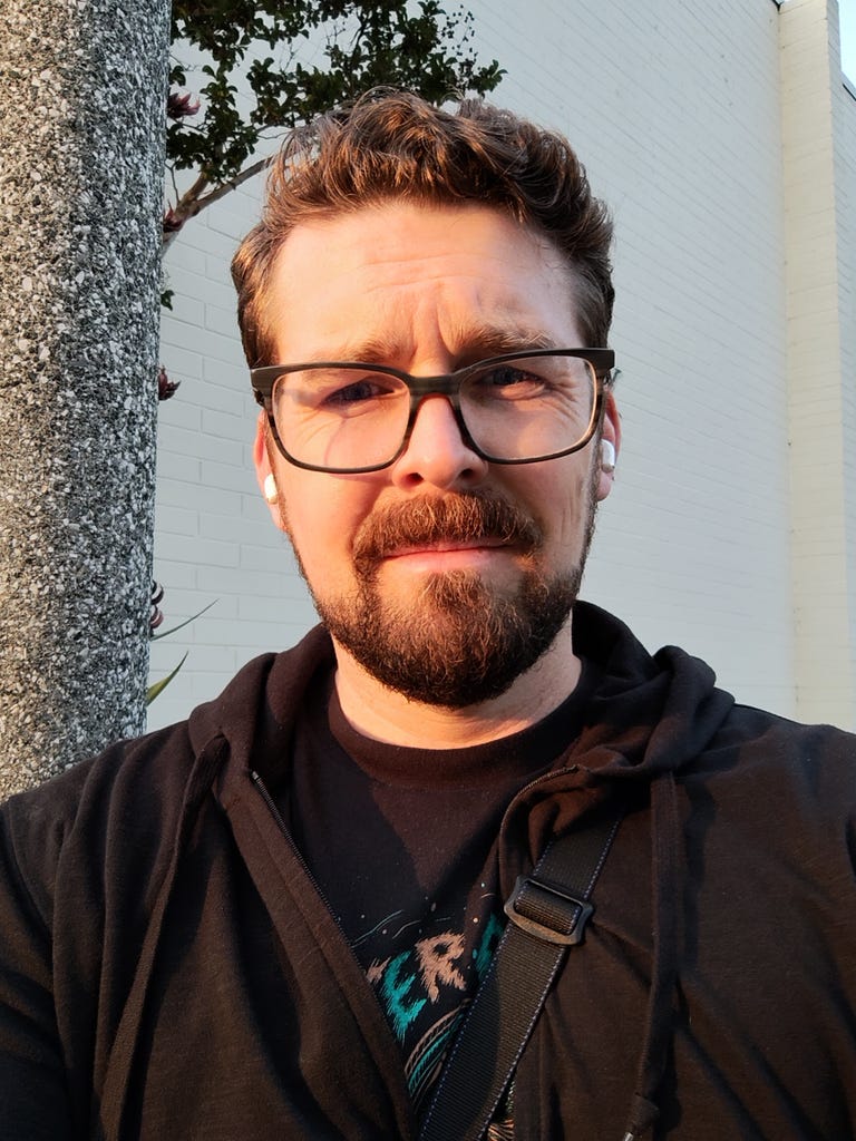 A selfie of a man at dusk.