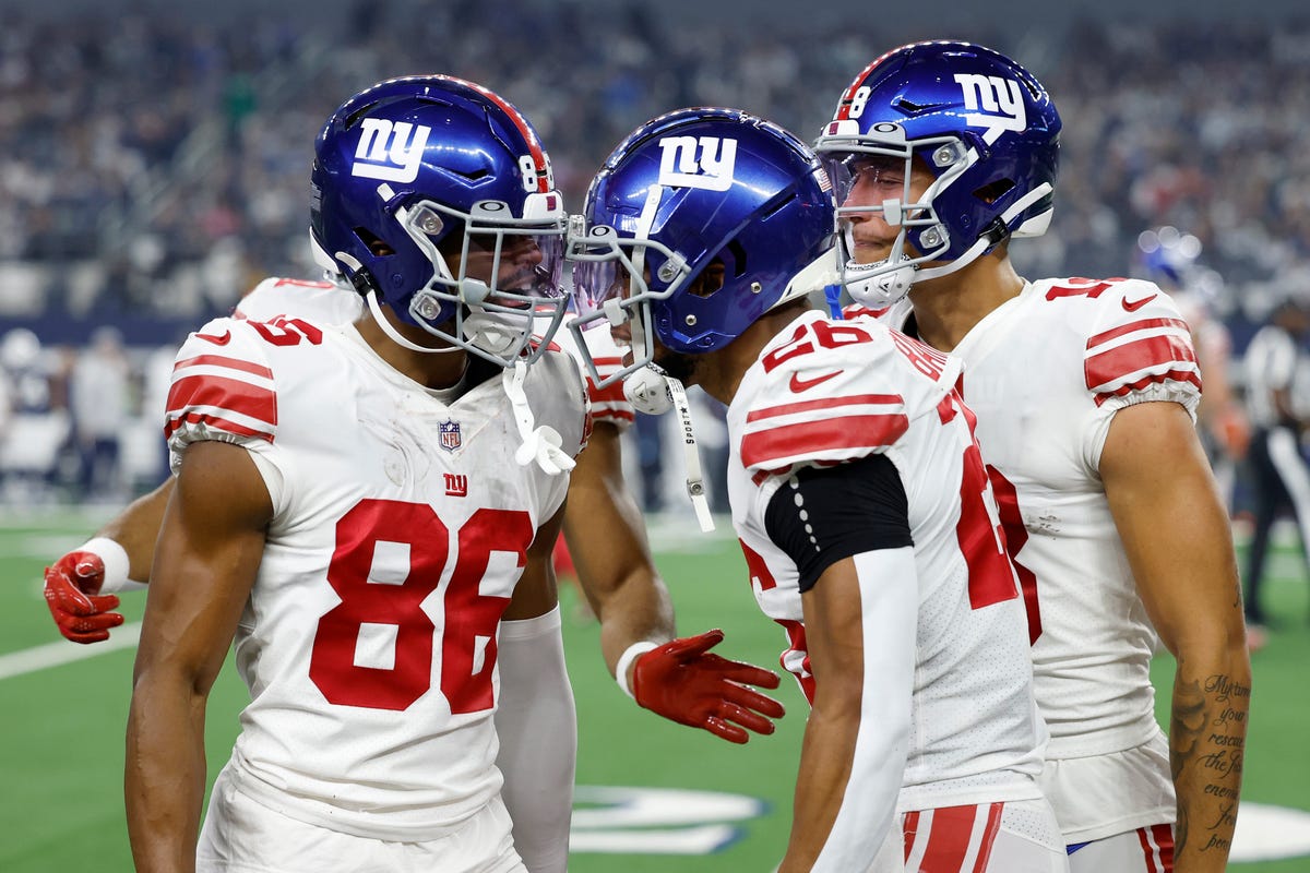 New York Giants football players celebrate a touchdown.