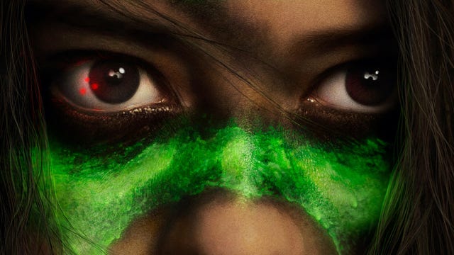 Prey poster features red dots shining in a woman's eye. She has luminous green warpaint on her face.