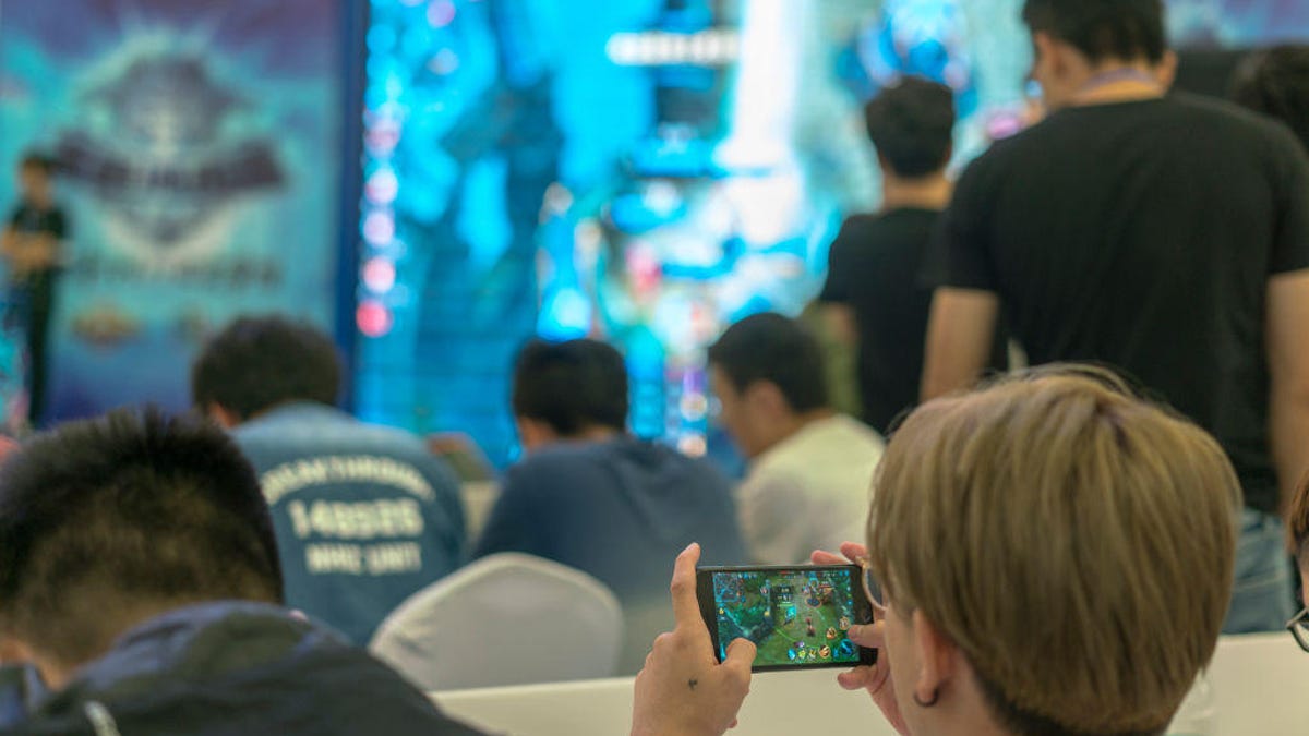 Young players compete in a battle match of the mobile game
