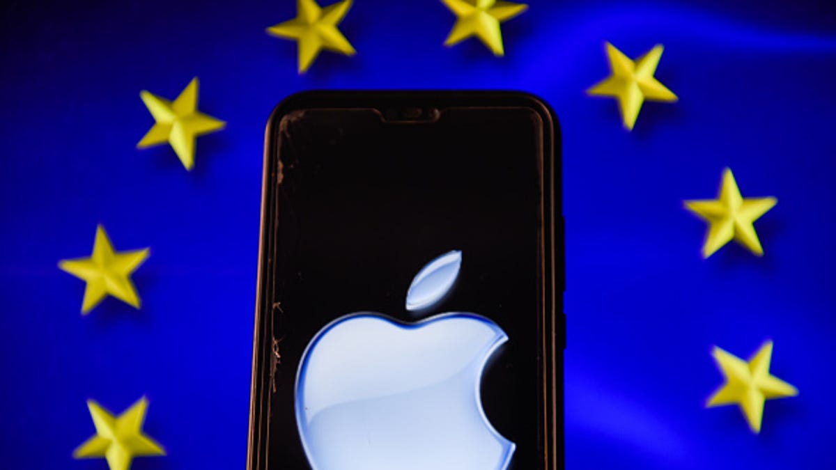Illustration of the Apple logo on a smartphone screen against an EU flag.