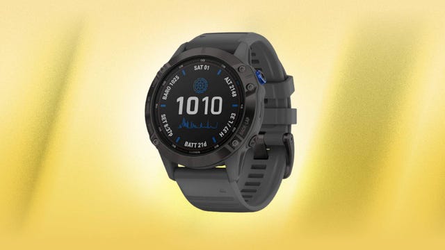 The Fenix 6 Pro Solar smartwatch is displayed against a yellow background.