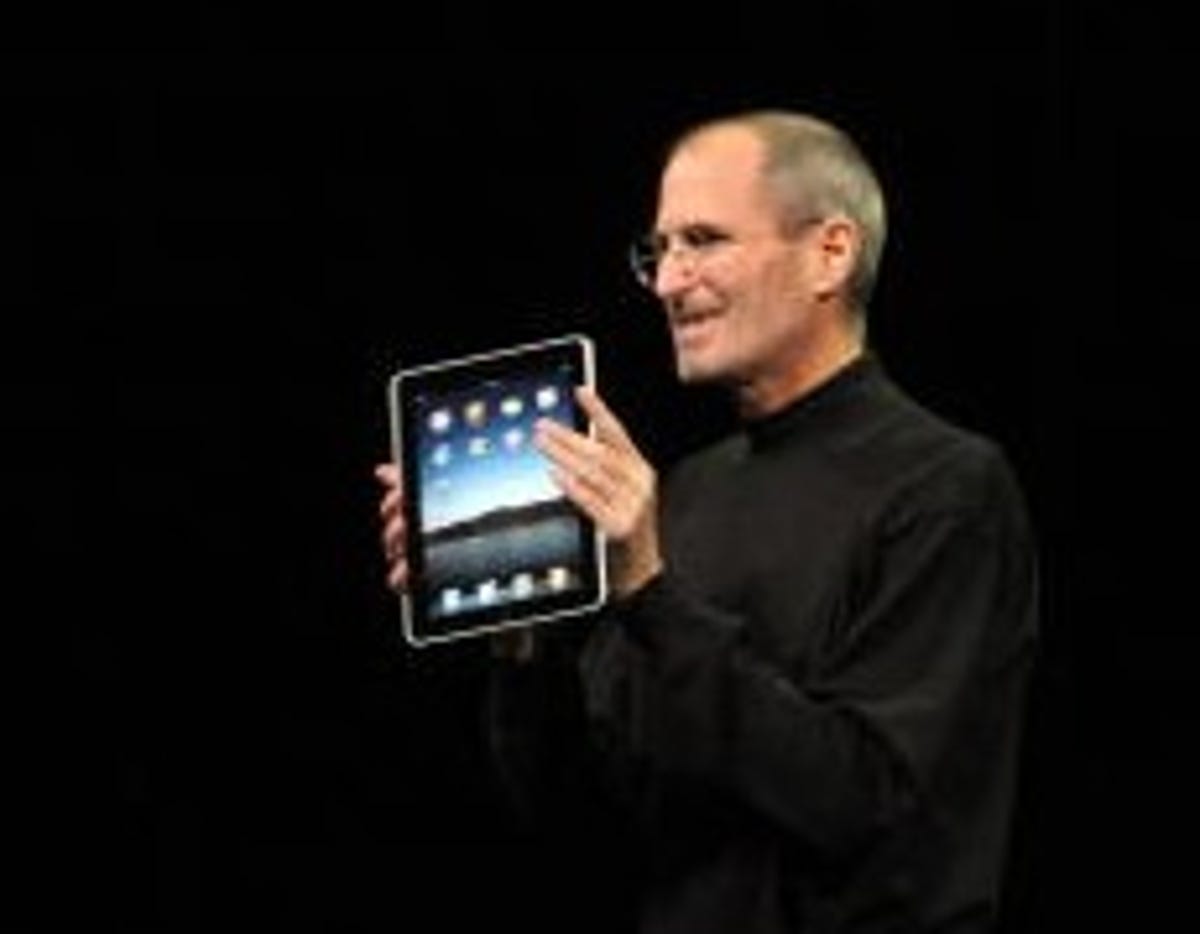 Apple CEO Steve Jobs, seen here showing off the iPad in January, made his first appearance on an earnings call in two years.